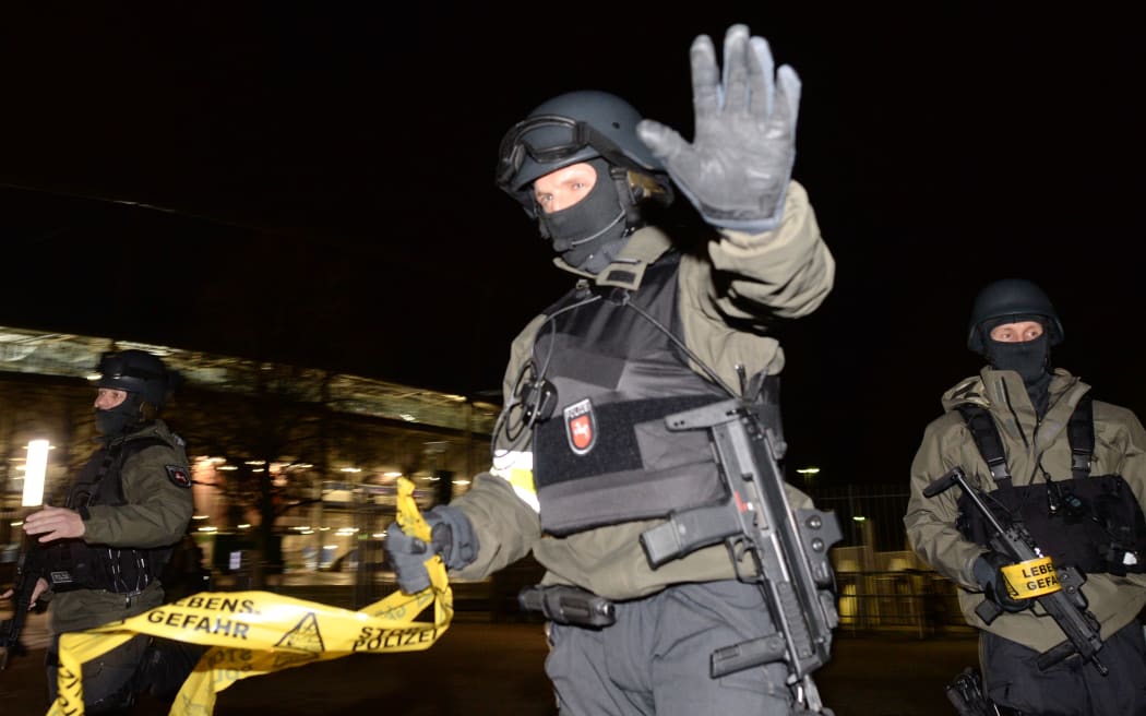 Police with assault rifles stand in front of the closed HDI Arena in Hanover.