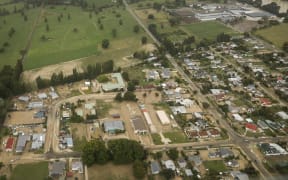 Wairoa from the air shows flood waters and mud throughout the town