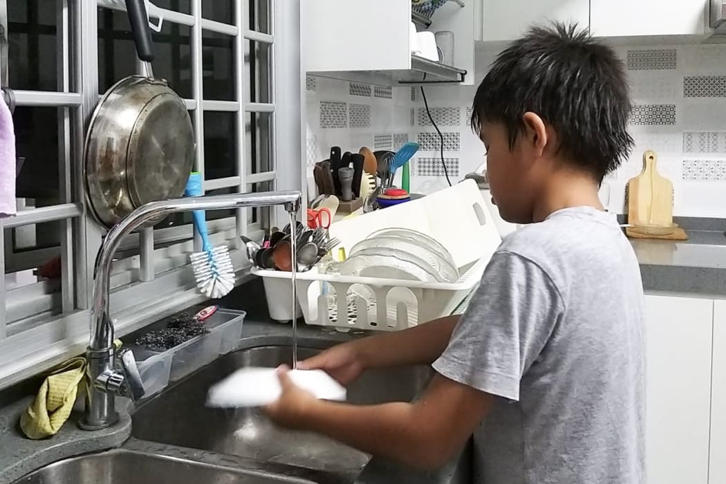 Hamimah's two sons help out with the chores in their Singapore apartment.