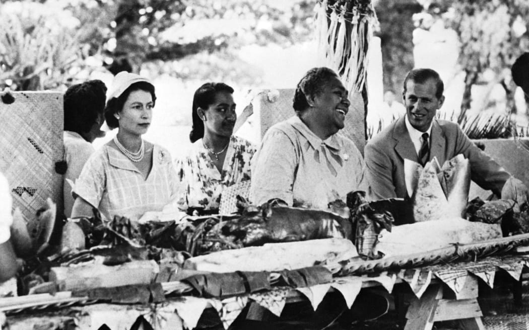 Queen of Tonga Salote Tupou III (C) gives a reception in honour of Queen Elizabeth II (L) and her husband Prince Philip, Duke of Edinburgh (R)'s visit, on December 30, 1953 in Polynesia.