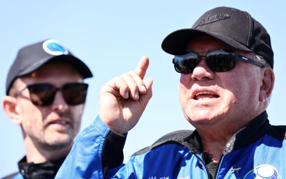 Star Trek actor William Shatner (R) speaks to media on the landing pad of Blue Origin's New Shepard as Planet Labs co-founder Chris Boshuizen looks on. The pair flew into space on October 13, 2021 near Van Horn, Texas.