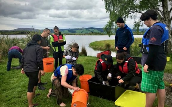 Tuna (eel) monitoring with rakatahi (youth) at Te Nohoaka o Tukiauau. All identifiable individuals have consented to the use of this image.