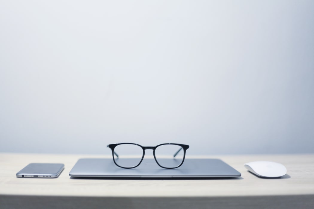 laptop, phone, mouse and sunglasses