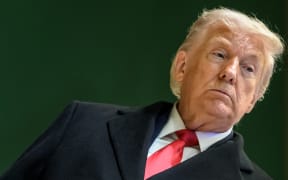 US President Donald Trump looks on as he leaves the congress centre during the World Economic Forum (WEF) annual meeting in Davos on January 21, 2026. The World Economic Forum takes place in Davos from January 19 to January 23, 2026. (Photo by Fabrice COFFRINI / AFP)