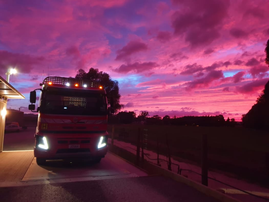 A logging truck at sunrise