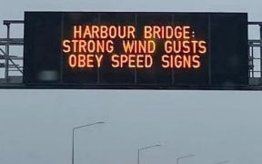 A motorway overhead sign on Auckland's Northern Motorway warns of wind gusts ahead of thunderstorms expected to arrive in Auckland