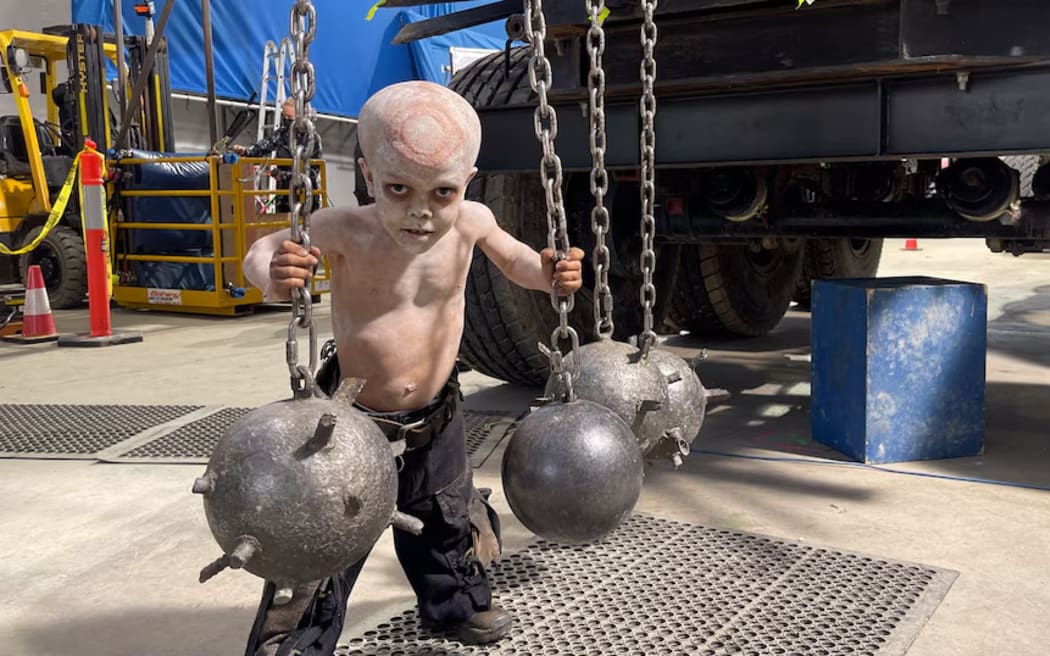 Quaden on the Furiosa set, dressed as the War Pup who is in charge of engaging these deadly "bommy knockers".