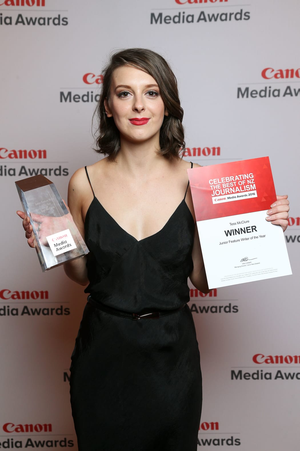 Tess McClure with her Junior Feature Writer of the Year trophy and certificate.