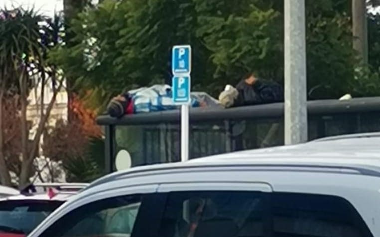 A person spotted sleeping on top of the bus stop beside Clive Square in central Napier.