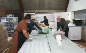 Volunteers prepare meals at Papakura Marae for those in need as unemployment rises.