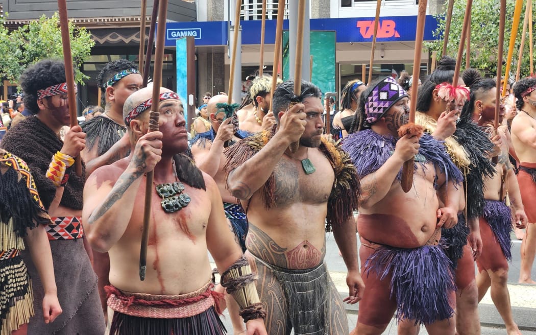 The head of the hīkoi is crossing Taranaki Street onto Manners Street.