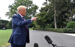 US President Donald Trump speaks to the press before departing from the White House in Washington,DC.