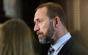Minister for Justice Andrew Little answers media questions before heading into the debating chamber.