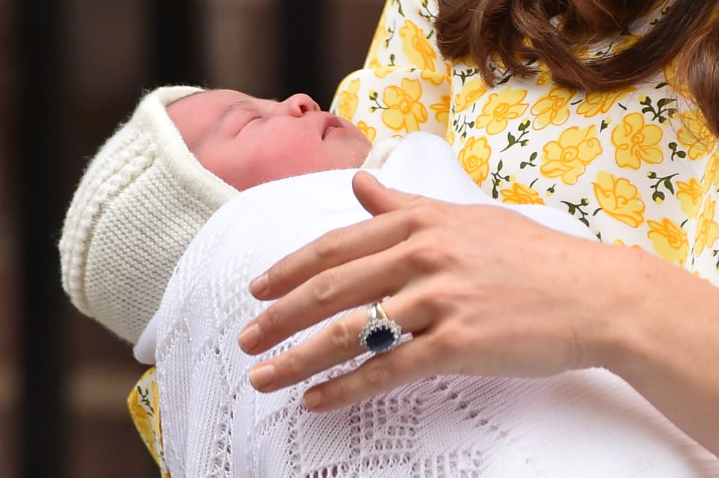 Catherine, Duchess of Cambridge holds her newly-born daughter.