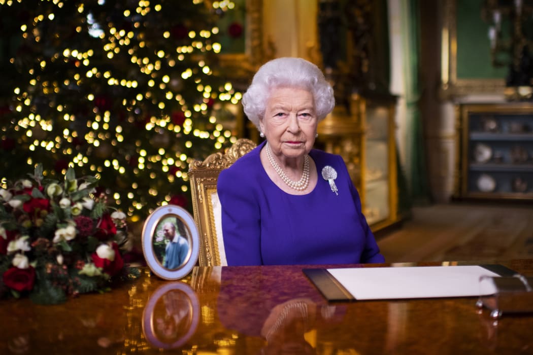 A picture released on 24 December 2020 shows Britain's Queen Elizabeth II posing for a photograph after she recorded her annual Christmas Day message, in Windsor Castle.