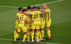 Wellington Phoenix captain Steven Taylor in a huddle with his teammates.