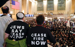 People demonstrate calling for a cease-fire amid war between Israel and Hamas, at Grand Central Station in New York City on 27 October 2023.