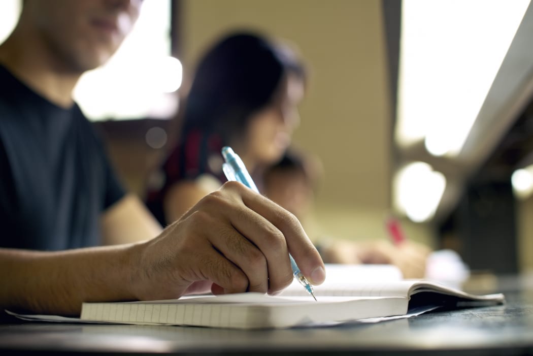 University or secondary school students study in a classroom.