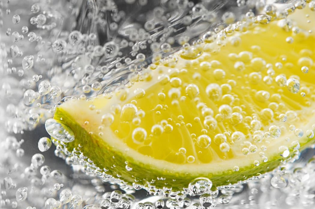 Abstract of lime and bubbles in a gin and tonic