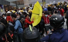 Protesters carrying umbrellas, the symbol of the pro-democracy movement, fought police armed with pepper spray and batons.