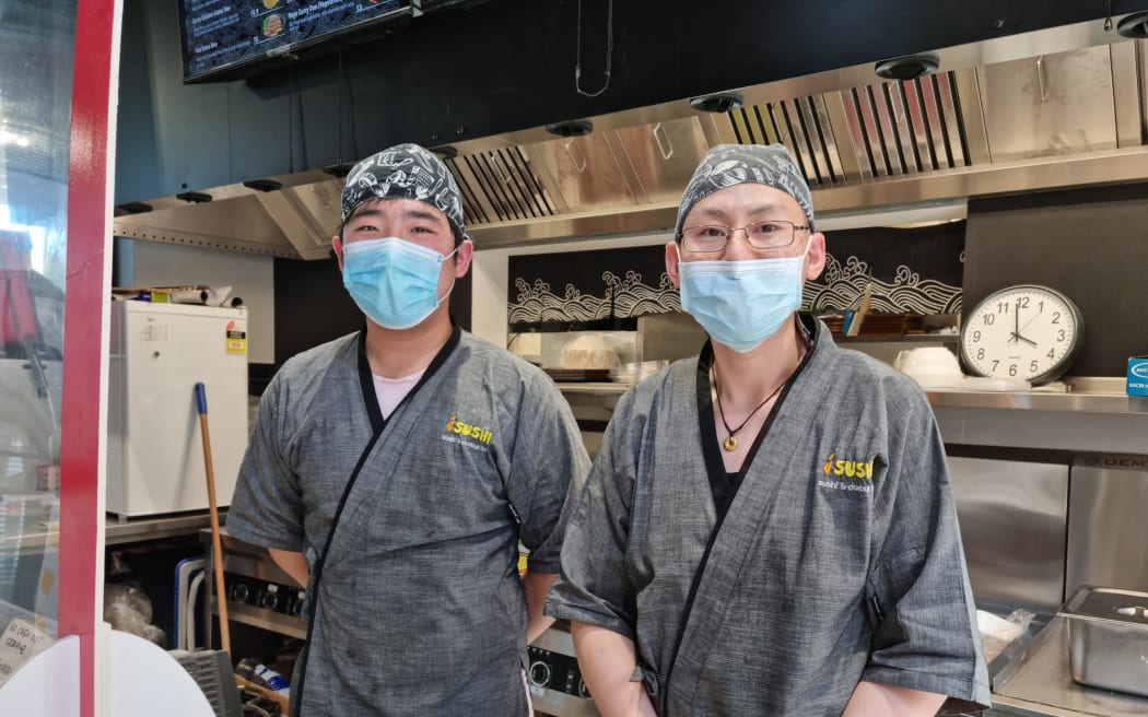 Huyeh Max and workmate Klein (left) say their iSushi bus interchange store has been targeted by young people every afternoon for the past four months.