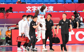Tacko Fall leaves the court after suffering an injury playing for Chinese Basketball Association club the Xinjiang Flying Tigers.
