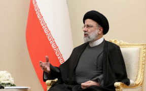 President of Azerbaijan Ilham Aliyev (not seen) meets Iranian President Ebrahim Raisi within the 15th Summit of Economic Cooperation Organization in Ashgabat, Turkmenistan on November 28, 2021.