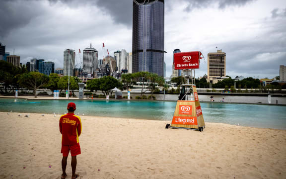 A lifeguard stands watch over a deserted South Bank beach on the first day of a snap lockdown in Brisbane on 9 January