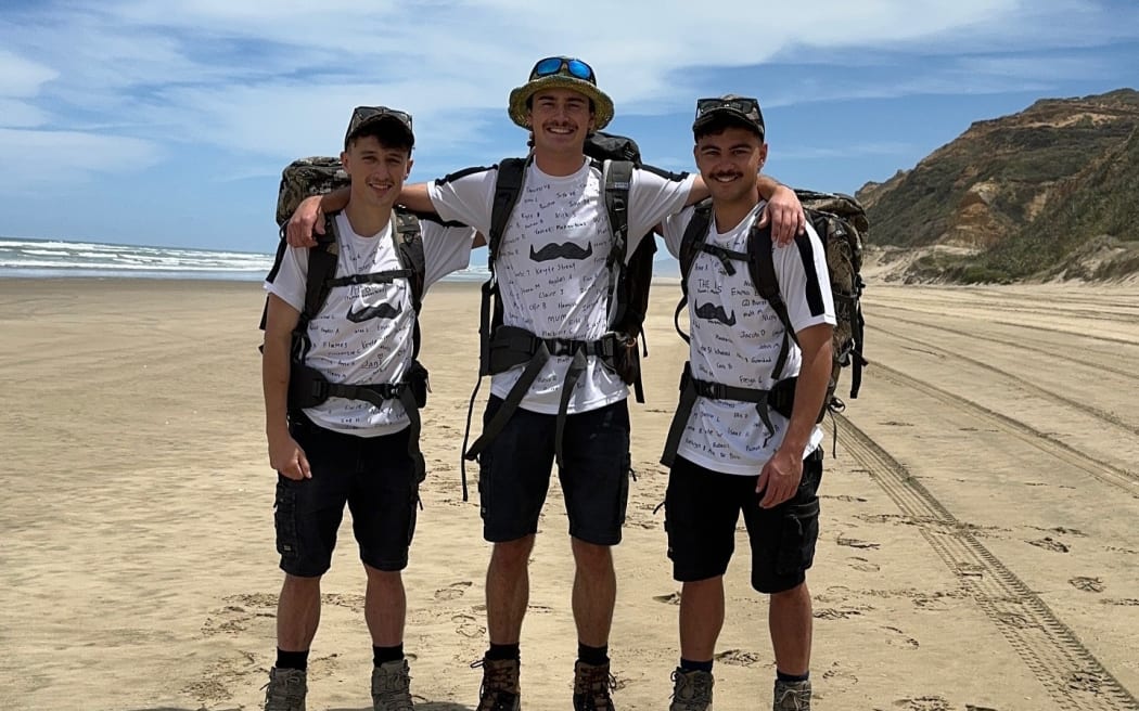 From left, Alex Smith, Tane Tarlton and Ben Reeve. The trio are standing on the beach with their tramping gear on.