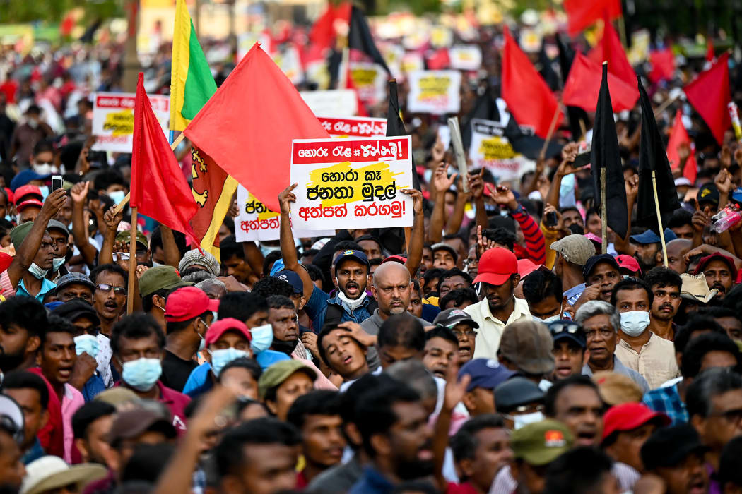 Janatha Vimukthi Peramuna party activists and supporters shout anti-government slogans during a demonstration in Colombo on April 19, 2022.