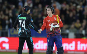 Harry Brook (R) and New Zealand's Mitchell Santner after a T20 international match in Chester-le-Street.