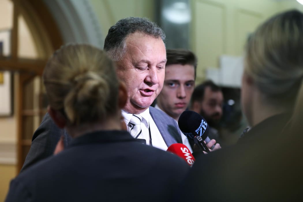 Newstalk ZB political reporter Aaron Dahmen (behind) recording Shane Jones’ remarks as he makes his way into the House. No caption