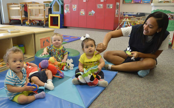 childcare teacher with 3 babies