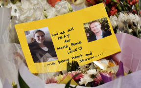 A card shows photos of Katrina Dawson (left) and Tori Johnson - the two hostages killed during the siege.