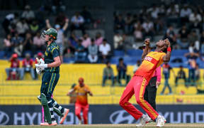 Zimbabwe's Blessing Muzarabani (R) celebrates after taking the wicket of Australia's Matt Renshaw during the 2026 ICC Men's T20 Cricket World Cup group stage match between Australia and Zimbabwe at the R Premadasa Stadium in Colombo on February 13, 2026. (Photo by Ishara S. KODIKARA / AFP)