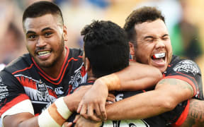 Issac Luke celebrates his try with Sam Lisone and Jazz Tevaga.