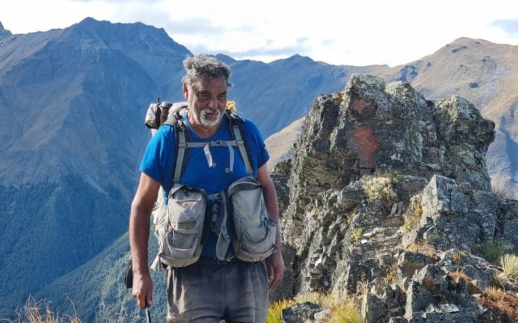 Image of Paul Roy tramping on mountain range.