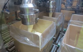 Hot cream cheese being packed at Fonterra's Darfield plant for Asian markets.