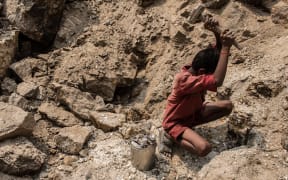Boy mining mica