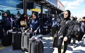 Members of Iran's women's football team exit Igdir airport, waiting to reach Dogubeyazit, in Igdir on March 18, 2026. The Iranian women's national football team landed at Istanbul Airport on March 17, 2026 after several members of the delegation withdrew their asylum bids in Australia and decided to return home.