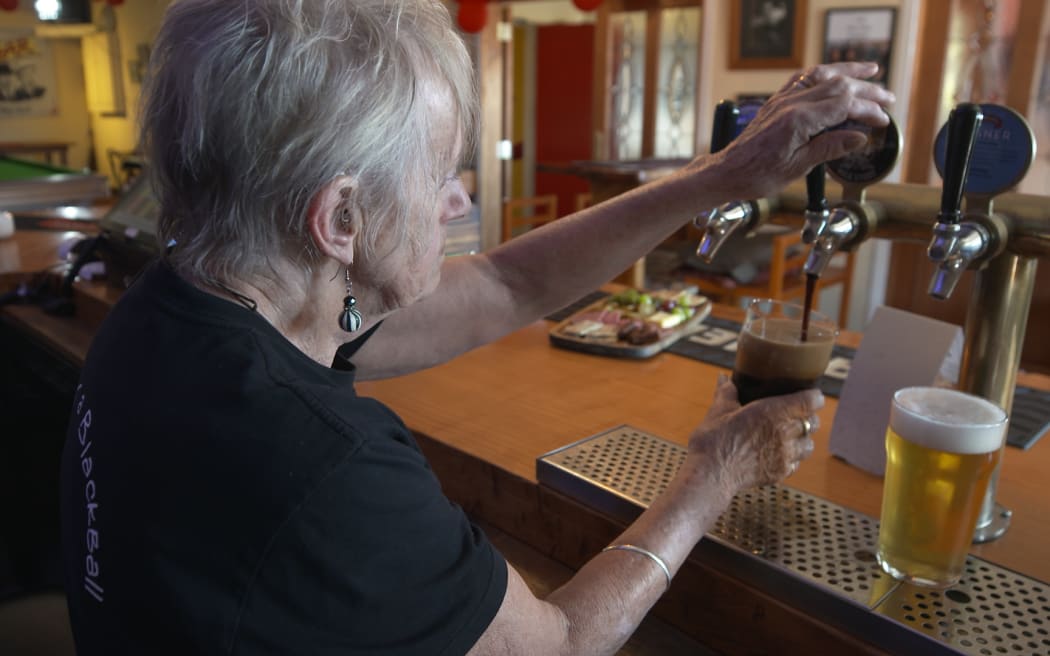 Jane Wells pulls a pint at The Blackball Inn.