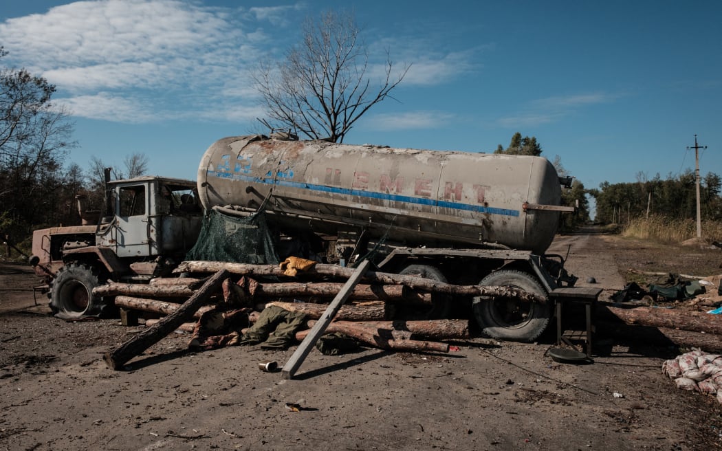 A destroyed oil truck, which is used to block a road by Russian forces at a checkpoint during the occupation, is seen near the recently retaken town of Lyman in Donetsk region on October 6, 2022, amid the Russian invasion of Ukraine.