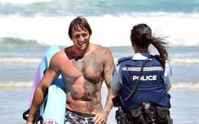 Rob Ratten who helped save swimmers talks to police at St Kilda beach on Monday afternoon.