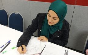 Young woman in green headscarf