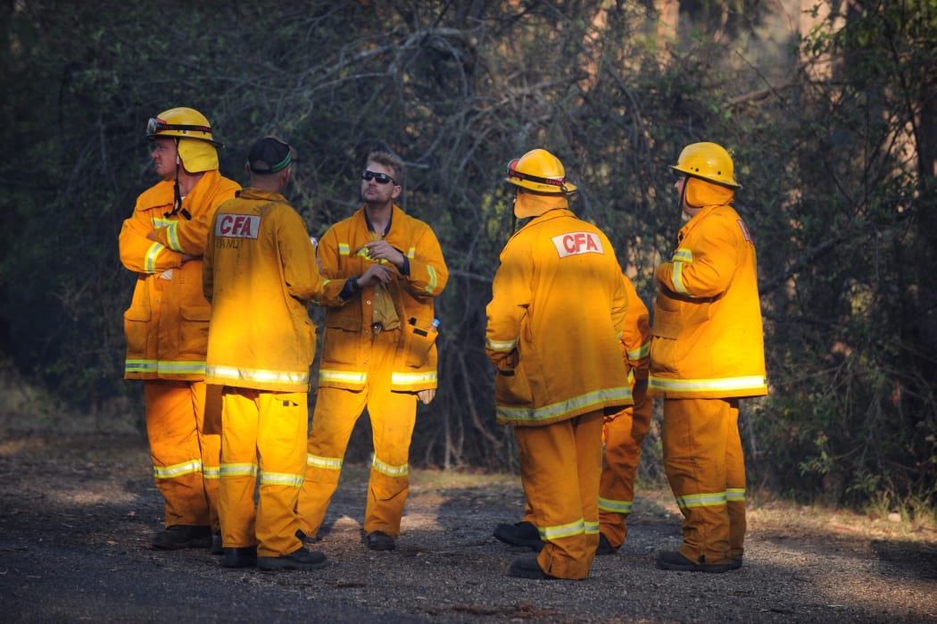 Firefighters take a break from their intense efforts.
