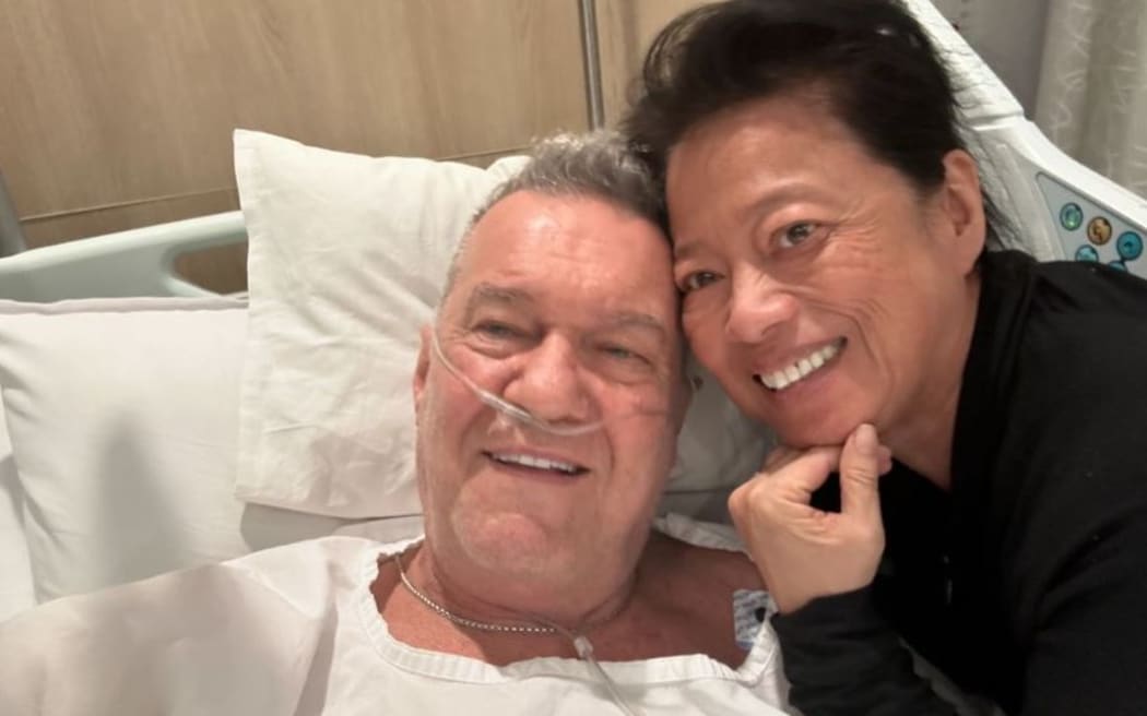 Jimmy Barnes in a hospital bed in August, 2024 with wife Jane Mahoney at his side.