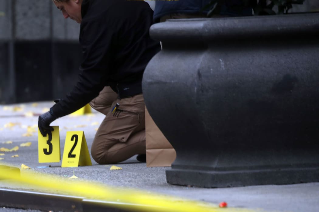 Police place bullet casing markers outside of a Hilton Hotel in Midtown Manhattan in New York, where United Healthcare CEO Brian Thompson was fatally shot on Wednesday, December 4.