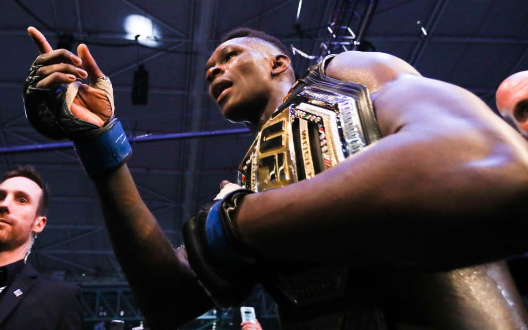 Israel Adesanya celebrates after defeating Robert Whittaker of Australia during the middleweight title bout of the UFC 243 fight night in Melbourne on October 6, 2019