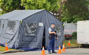 An armed guard outside Stanbury Avenue house in Somerfield, Christchurch