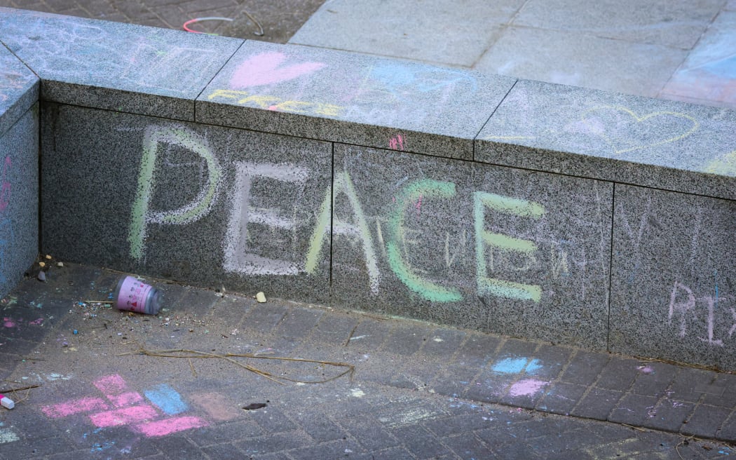 'Peace' scrawled in coloured chalk on the Parliamentary forecourt